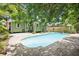 Outdoor oasis with a stunning pool, lush landscaping and a green house at 6006 N Highland Ave, Tampa, FL 33604