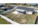 Aerial view of the fenced backyard with screened porch and concrete patio at 6110 16Th St, Zephyrhills, FL 33542
