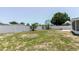 Spacious backyard featuring a white vinyl fence and some green grass at 6110 16Th St, Zephyrhills, FL 33542