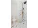 Stylish bathroom showcasing marble tile and black rainfall shower with gold-tone accents at 6110 16Th St, Zephyrhills, FL 33542