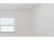 Bright and airy bedroom showing a window with blinds and white walls at 6110 16Th St, Zephyrhills, FL 33542