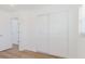 Minimalist bedroom showcasing closet space and modern wood-look floors at 6110 16Th St, Zephyrhills, FL 33542
