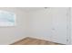 Bright bedroom features natural light, wood-look floors, and a fresh, neutral color palette for versatile décor options at 6110 16Th St, Zephyrhills, FL 33542