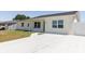 A newly poured concrete driveway leading to a freshly painted charming one-story home at 6110 16Th St, Zephyrhills, FL 33542
