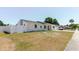 Exterior shot of the home showing the manicured yard and white picket fence at 6110 16Th St, Zephyrhills, FL 33542