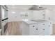 Kitchen island featuring cooktop, quartz countertop, and natural light, with white cabinetry at 6110 16Th St, Zephyrhills, FL 33542
