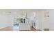 Bright, white kitchen with stainless steel appliances, island, quartz countertops, and natural light at 6110 16Th St, Zephyrhills, FL 33542