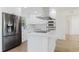 Bright kitchen boasts stainless appliances, white cabinets, quartz countertops, and sleek range hood at 6110 16Th St, Zephyrhills, FL 33542