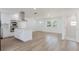 Open-concept living room featuring a modern kitchen island and bright natural light at 6110 16Th St, Zephyrhills, FL 33542