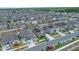 Aerial view of a modern residential community with well-maintained homes, green spaces, and neighborhood streets at 7114 Fern Garden Ct, Sun City Center, FL 33573