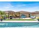 Inviting backyard oasis with a sparkling pool, lounge chairs, and covered dining area at 7114 Fern Garden Ct, Sun City Center, FL 33573