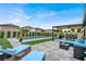 Stunning backyard featuring a pristine pool, pergola, and comfortable lounge area at 7114 Fern Garden Ct, Sun City Center, FL 33573