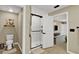 Bathroom showcasing white shower with black hardware and doorway to toilet and separate doorway to bedroom at 7114 Fern Garden Ct, Sun City Center, FL 33573