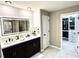 Bathroom features dual vanity with vessel sinks, shiplap accent wall, and a view of a walk-in closet at 7114 Fern Garden Ct, Sun City Center, FL 33573