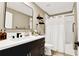 Modern bathroom featuring a sleek vanity with dark cabinets, white countertop, and walk-in shower at 7114 Fern Garden Ct, Sun City Center, FL 33573