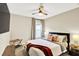 Comfortable bedroom with neutral tones, a cozy bed, and a ceiling fan at 7114 Fern Garden Ct, Sun City Center, FL 33573