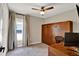 Comfortable bedroom featuring a murphy bed and adjacent desk area at 7114 Fern Garden Ct, Sun City Center, FL 33573