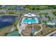 Aerial view of a community pool, playground, and clubhouse, offering residents recreation and relaxation at 7114 Fern Garden Ct, Sun City Center, FL 33573