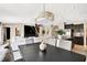 Open dining room with views of kitchen and living area, features a decorative lighting fixture and neutral color palette at 7114 Fern Garden Ct, Sun City Center, FL 33573