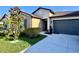 Charming single-story home featuring a well-manicured lawn and a convenient two-car garage at 7114 Fern Garden Ct, Sun City Center, FL 33573