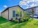 Lovely home with lush landscaping, showcasing vibrant green lawn and colorful plants at 7114 Fern Garden Ct, Sun City Center, FL 33573