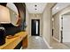 Stylish foyer with modern lighting, decorative mirror, and sleek console table at 7114 Fern Garden Ct, Sun City Center, FL 33573