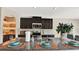 Modern kitchen with dark cabinets, granite countertops, stainless steel appliances, and decorative backsplash at 7114 Fern Garden Ct, Sun City Center, FL 33573