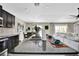 Stylish kitchen island with granite countertop and modern sink, flowing into living area at 7114 Fern Garden Ct, Sun City Center, FL 33573