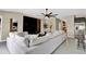 Open-concept living room with a large sectional sofa and stylish decor at 7114 Fern Garden Ct, Sun City Center, FL 33573