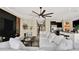Bright living room featuring a comfortable sectional sofa, modern ceiling fan, and open-concept design at 7114 Fern Garden Ct, Sun City Center, FL 33573
