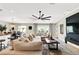 Spacious living room featuring a large sectional sofa, ceiling fan, and natural light at 7114 Fern Garden Ct, Sun City Center, FL 33573