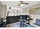 Inviting home office with custom built-ins, dark wood accents, and a modern adjustable desk at 7114 Fern Garden Ct, Sun City Center, FL 33573