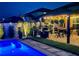 Outdoor patio area features a grill, dining table, and ambient string lights at 7114 Fern Garden Ct, Sun City Center, FL 33573