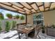 Covered outdoor dining area with hanging plants, perfect for enjoying meals outdoors at 7114 Fern Garden Ct, Sun City Center, FL 33573