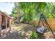 Spacious backyard with mature trees, a swing, and covered patio providing a private and tranquil outdoor space at 7401 11Th N Ave, St Petersburg, FL 33710