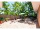 Charming backyard with brick patio, outdoor seating, lush trees, and a privacy fence, perfect for relaxation at 7401 11Th N Ave, St Petersburg, FL 33710