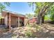 Backyard featuring a covered patio area, mature trees, and room for outdoor activities and landscaping at 7401 11Th N Ave, St Petersburg, FL 33710