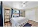 Bedroom with wood floors, a ceiling fan, and sliding closet doors at 7401 11Th N Ave, St Petersburg, FL 33710