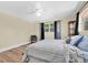 Cozy bedroom featuring wood floors, a ceiling fan, and a window at 7401 11Th N Ave, St Petersburg, FL 33710