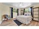 Bedroom with wood floors, a ceiling fan, and windows at 7401 11Th N Ave, St Petersburg, FL 33710