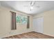Bedroom features a closet, wood-look floors, and fan at 7401 11Th N Ave, St Petersburg, FL 33710