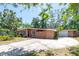 Inviting single-story home featuring a spacious driveway, lush landscaping, and a well-maintained exterior at 7401 11Th N Ave, St Petersburg, FL 33710