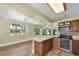 Bright kitchen featuring wood cabinets, stainless steel appliances, and a breakfast bar area at 7401 11Th N Ave, St Petersburg, FL 33710