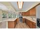 Bright kitchen featuring wood cabinets, stainless steel appliances, and a breakfast bar area at 7401 11Th N Ave, St Petersburg, FL 33710