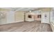 Open-concept living space with wood-look floors and a seamless transition to the adjacent kitchen at 7401 11Th N Ave, St Petersburg, FL 33710