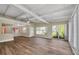 Spacious and bright living room featuring wood-look flooring and large windows for natural light at 7401 11Th N Ave, St Petersburg, FL 33710