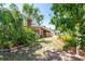 Side yard of a single-story home with lush landscaping, mature trees and ample space at 7401 11Th N Ave, St Petersburg, FL 33710
