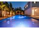 Night shot of the backyard pool and house, with tropical landscaping and backyard lighting at 790 36Th N Ave, St Petersburg, FL 33704
