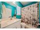 Bright bathroom with a white vanity, quartz countertop, and designer shower curtain at 790 36Th N Ave, St Petersburg, FL 33704