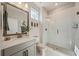 Bright bathroom with a glass shower enclosure, gray vanity with light countertop, and modern fixtures at 790 36Th N Ave, St Petersburg, FL 33704
